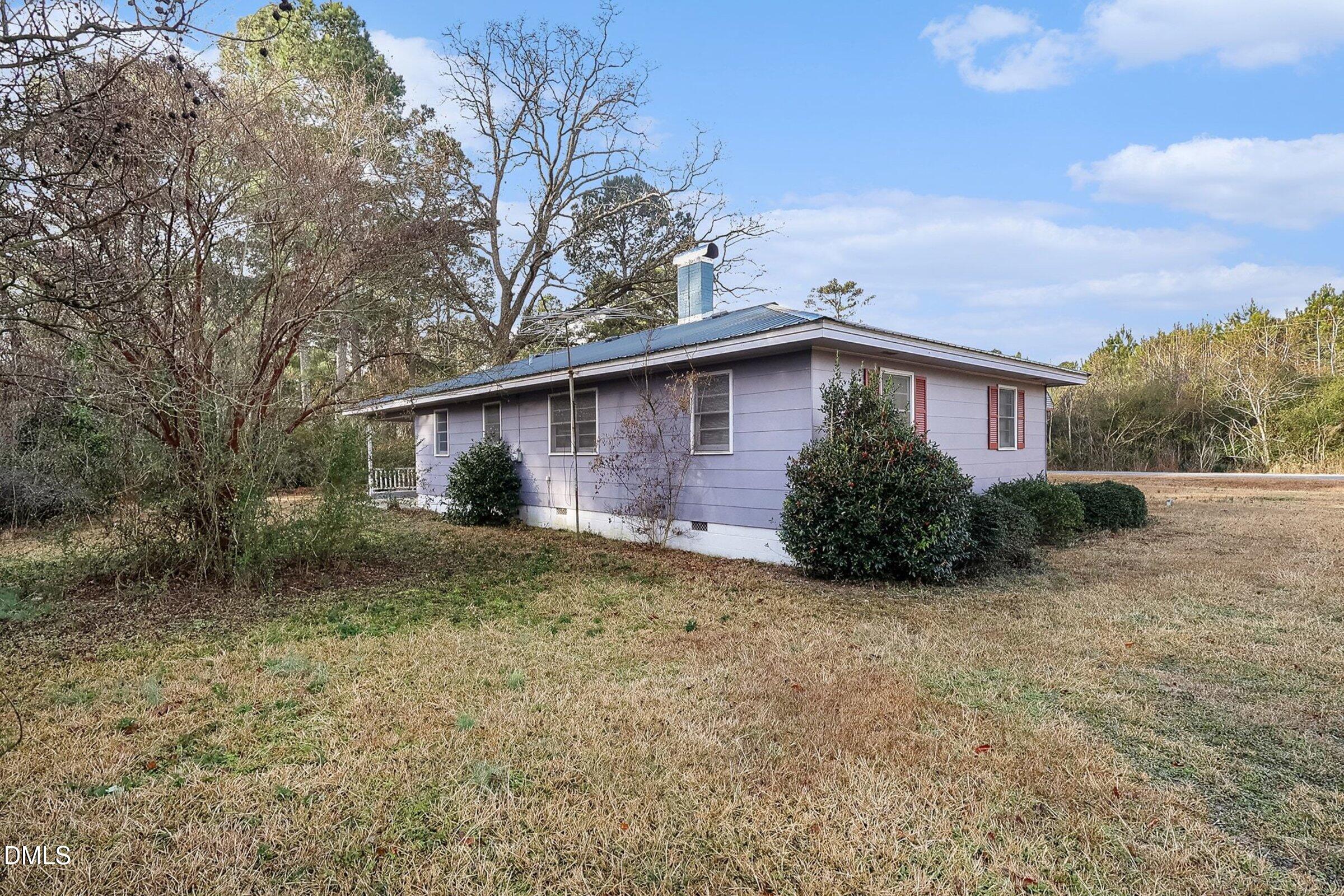 1249 Fann School Road Salemburg, NC 28385 - Photo 29 of 42 a view of a house with a large tree and a big yard