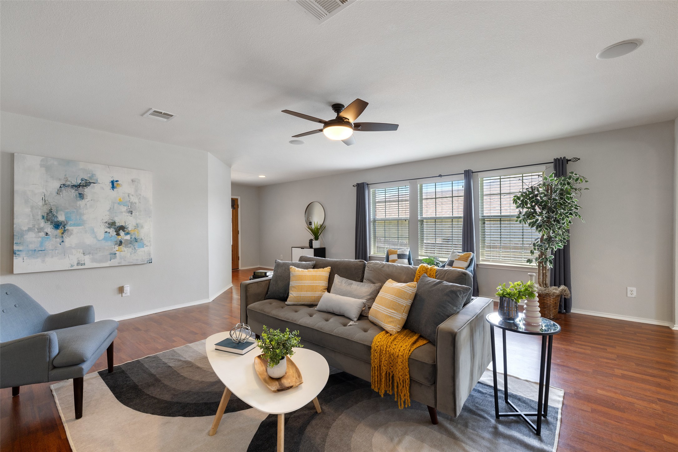 517 Castebar Drive Round Rock, TX 78664 - Photo 11 of 37 Living area with wood finished floors, ceiling fan, and baseboards