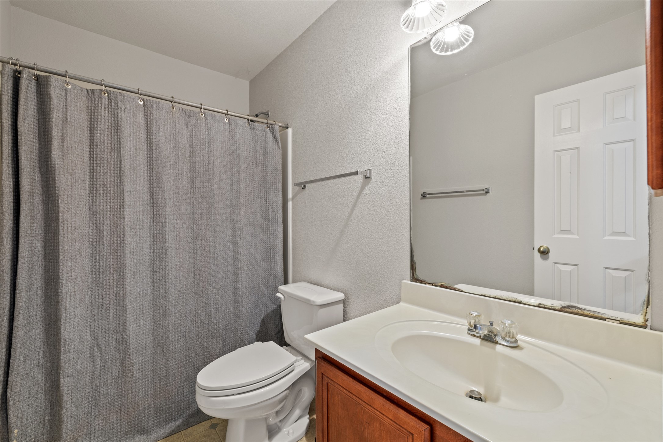 517 Castebar Drive Round Rock, TX 78664 - Photo 24 of 37 Bathroom with toilet, vanity, a shower with curtain, and a textured wall