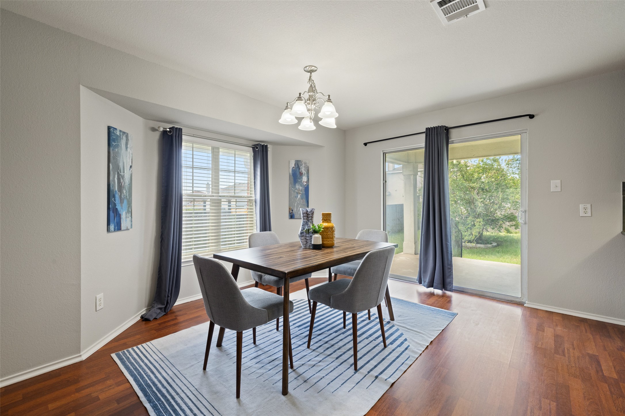 517 Castebar Drive Round Rock, TX 78664 - Photo 3 of 37 Dining space with a chandelier, plenty of natural light, baseboards, and dark wood finished floors