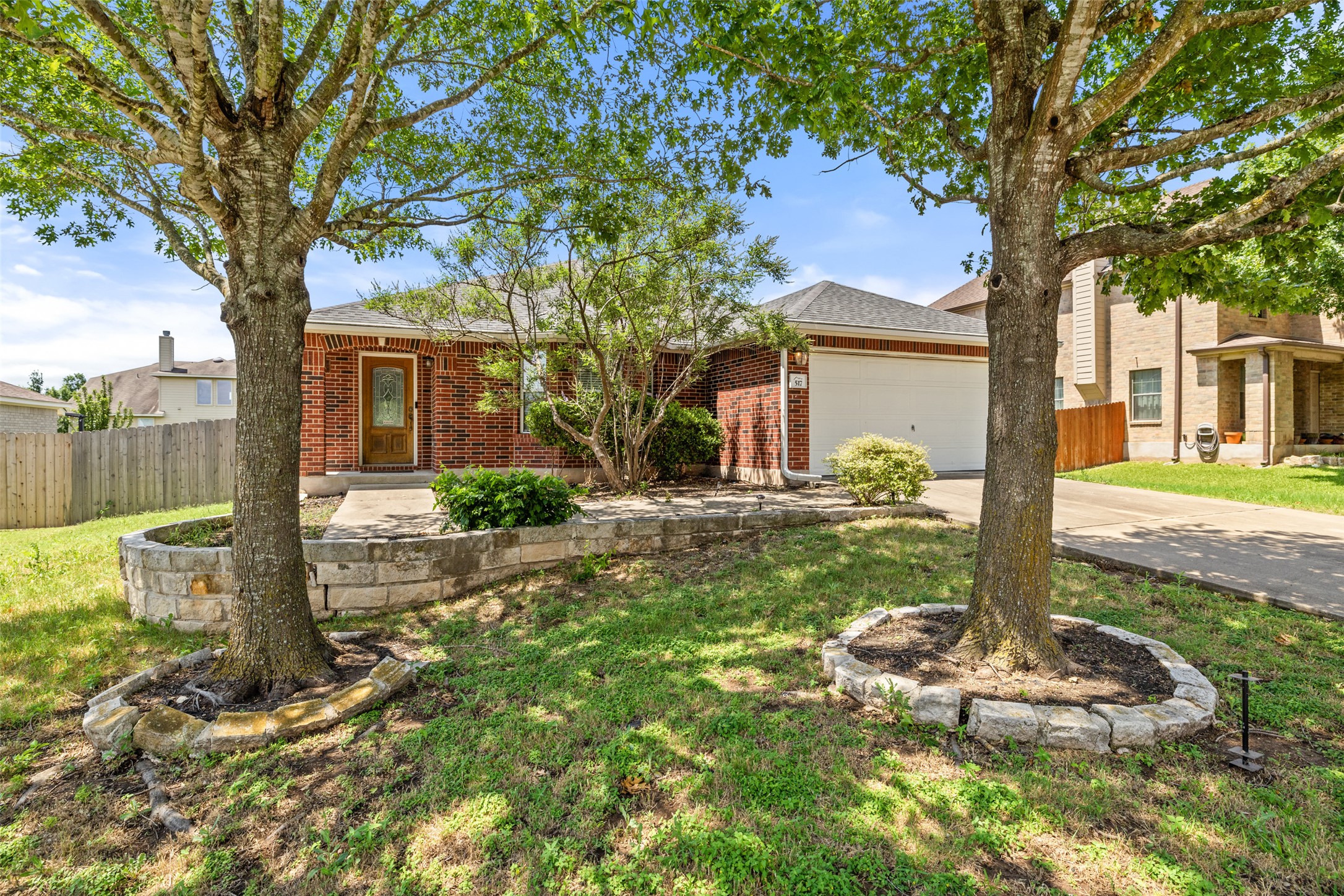 517 Castebar Drive Round Rock, TX 78664 - Photo 35 of 37 View of front of house with driveway, a garage, brick siding, and a shingled roof