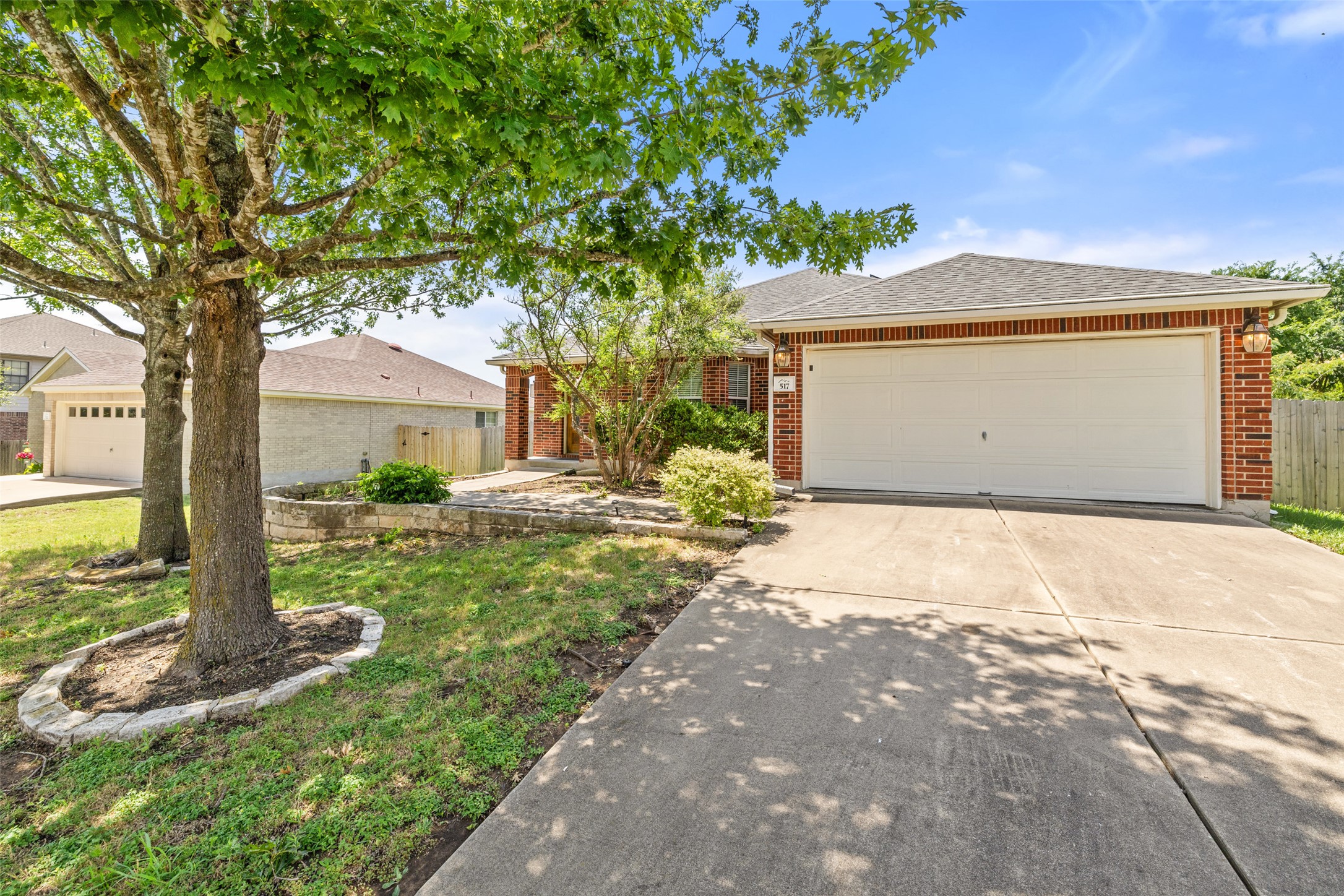 517 Castebar Drive Round Rock, TX 78664 - Photo 36 of 37 Ranch-style home featuring brick siding, concrete driveway, an attached garage, and roof with shingles