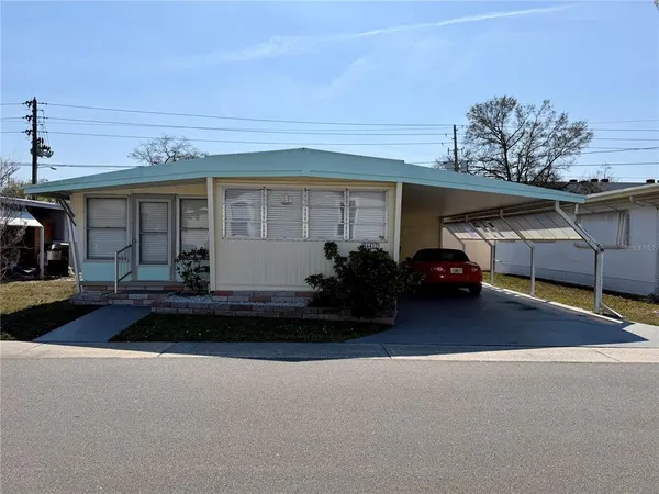 a couple of cars parked in front of a house