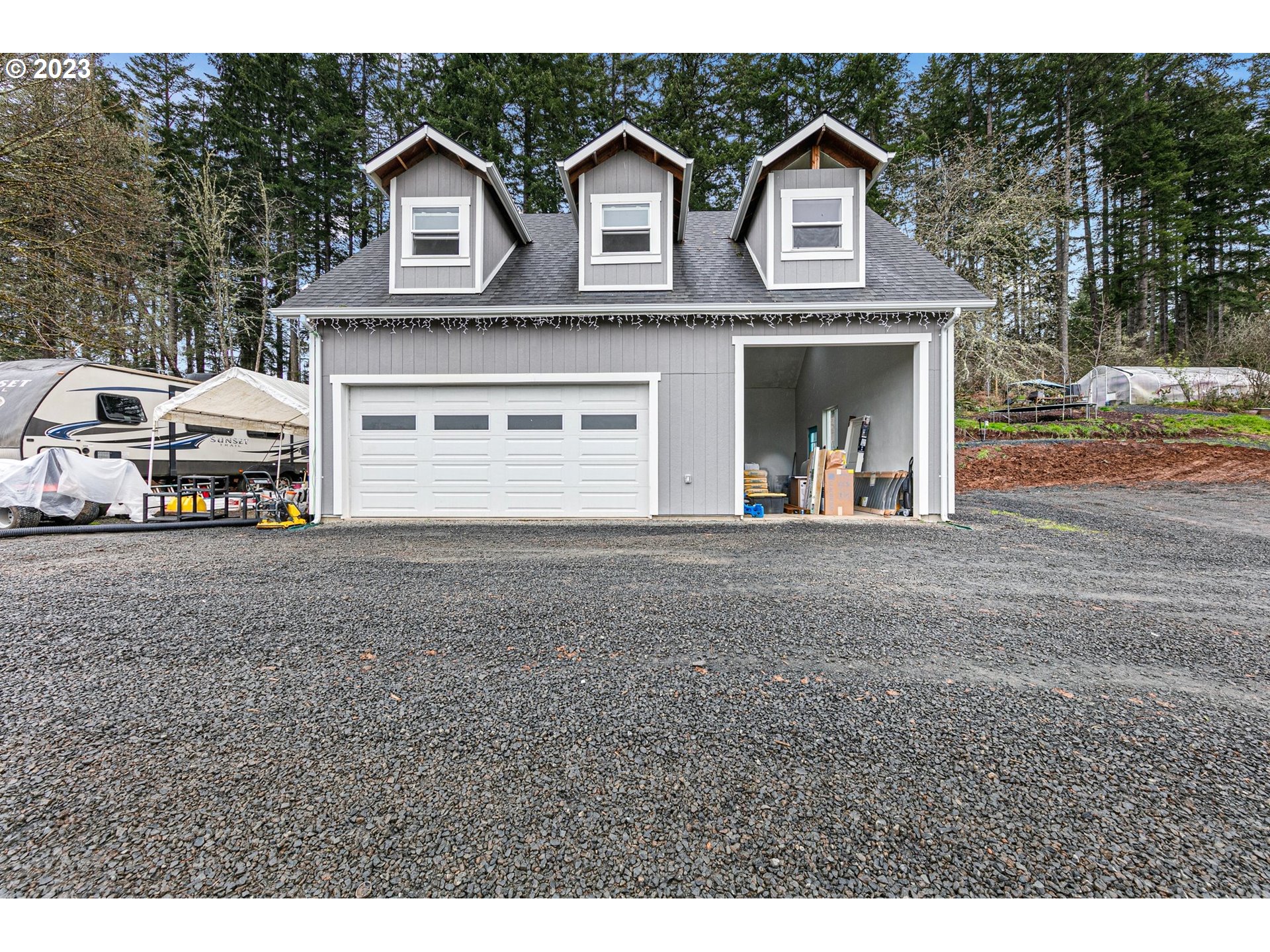 78124 Daybreak Drive Cottage Grove, OR 97424 - Photo 38 of 46 a view of a big house with large windows and a car parked