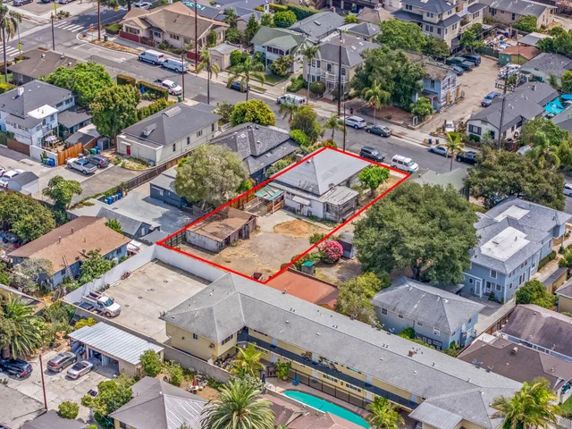 an aerial view of residential houses with outdoor space