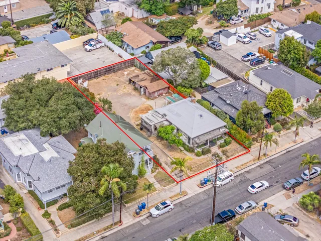 an aerial view of a city with lots of residential buildings and street
