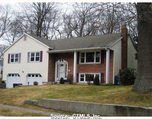 276 Ridgewood Drive Groton, CT 06355 - Photo 1 of 1 a view of a yard in front of a brick house with large windows