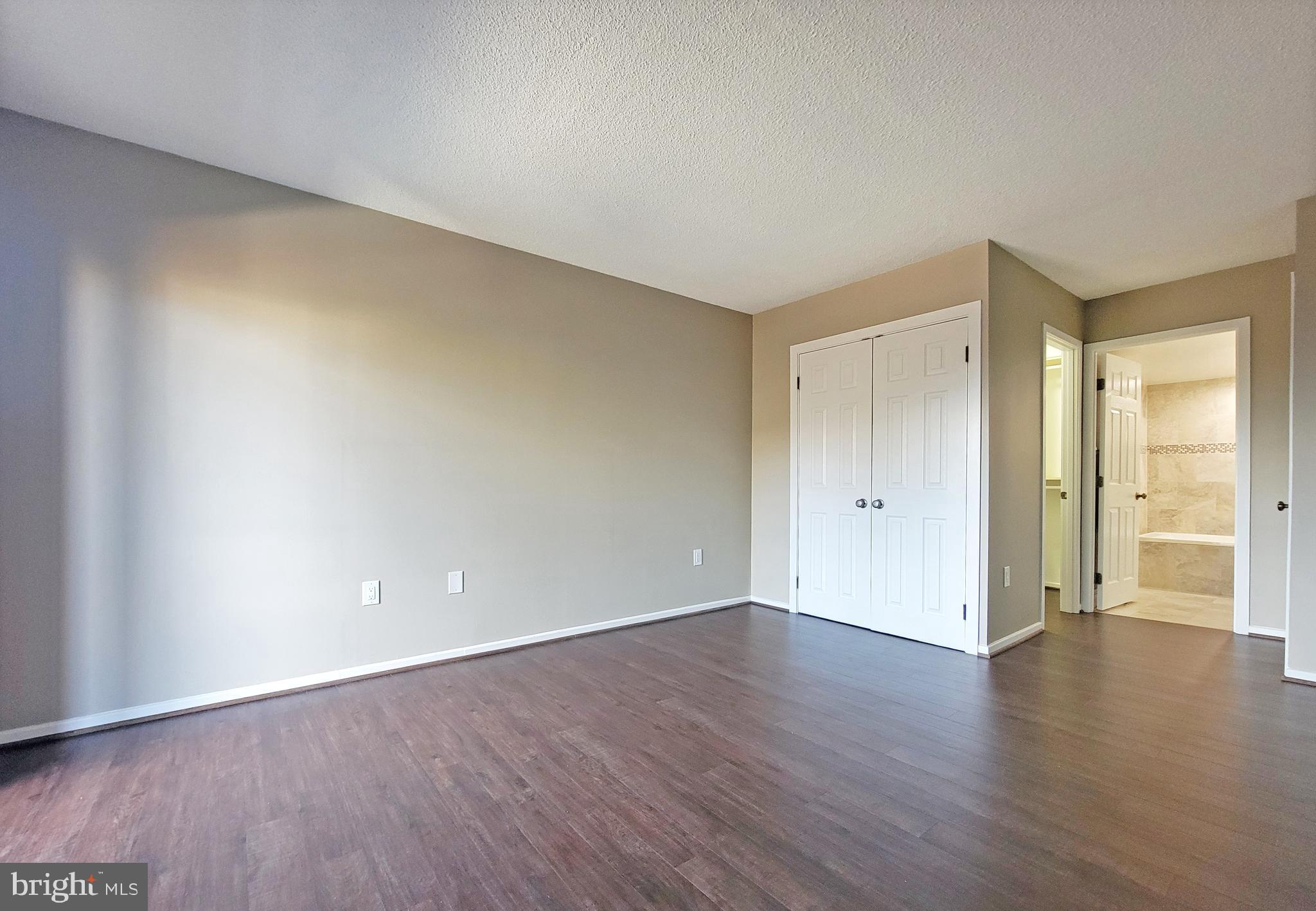 2111 Wisconsin Avenue Northwest, Unit 109 Washington, DC 20007 - Photo 20 of 50 a view of an empty room with wooden floor and closet