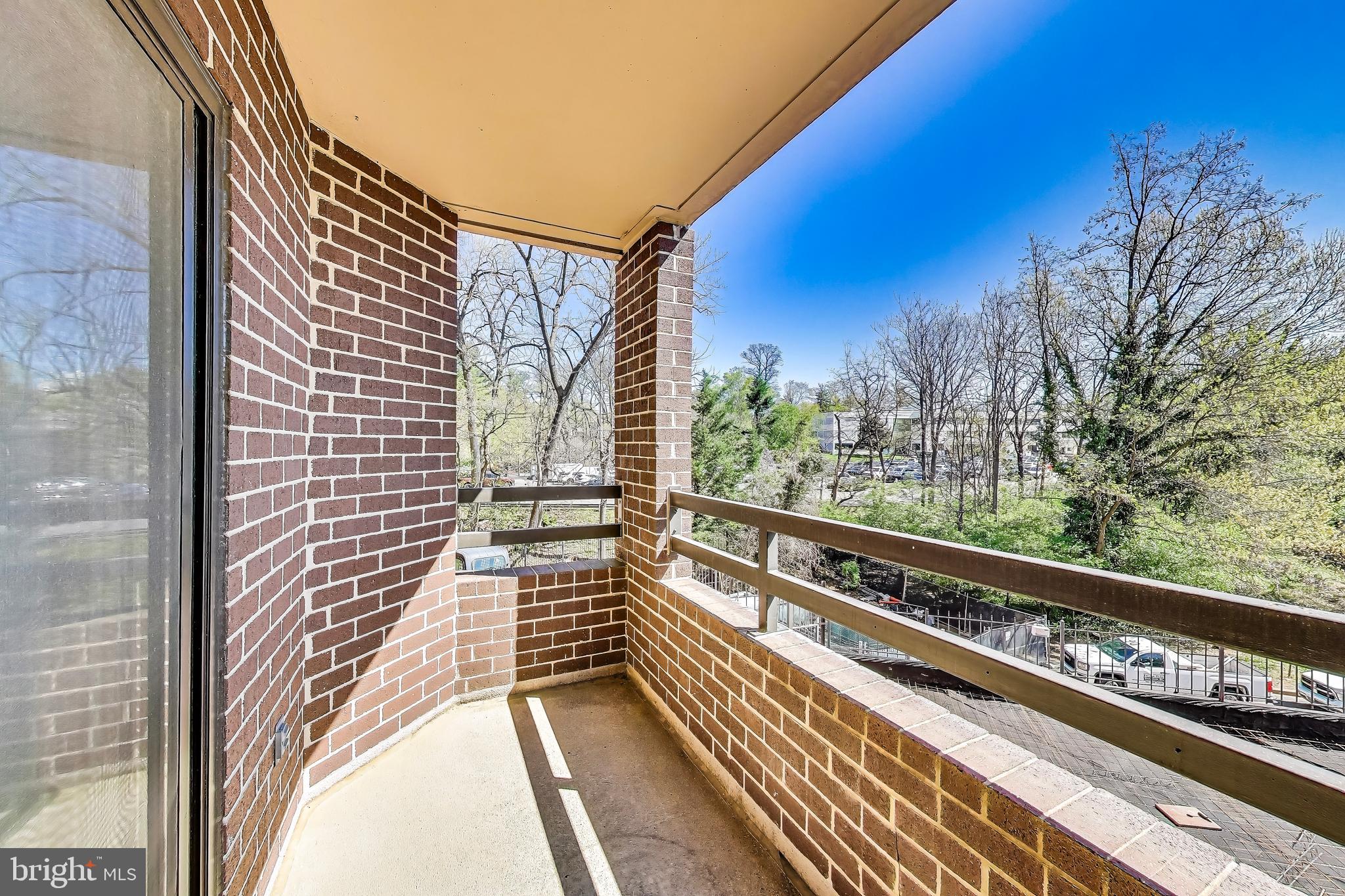2111 Wisconsin Avenue Northwest, Unit 109 Washington, DC 20007 - Photo 22 of 50 a view of balcony with wooden floor and fence