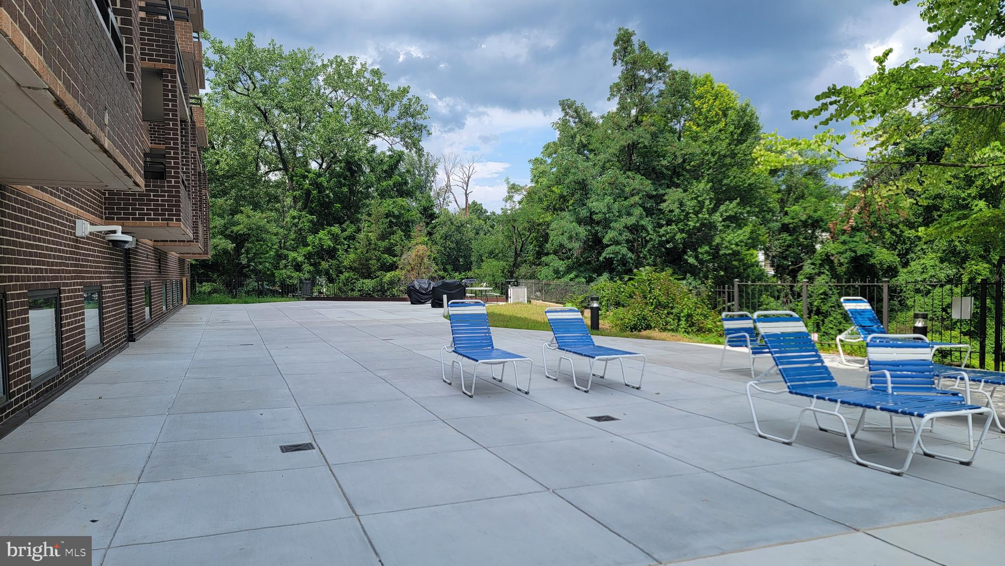 2111 Wisconsin Avenue Northwest, Unit 109 Washington, DC 20007 - Photo 37 of 50 a view of backyard with swimming pool and furniture