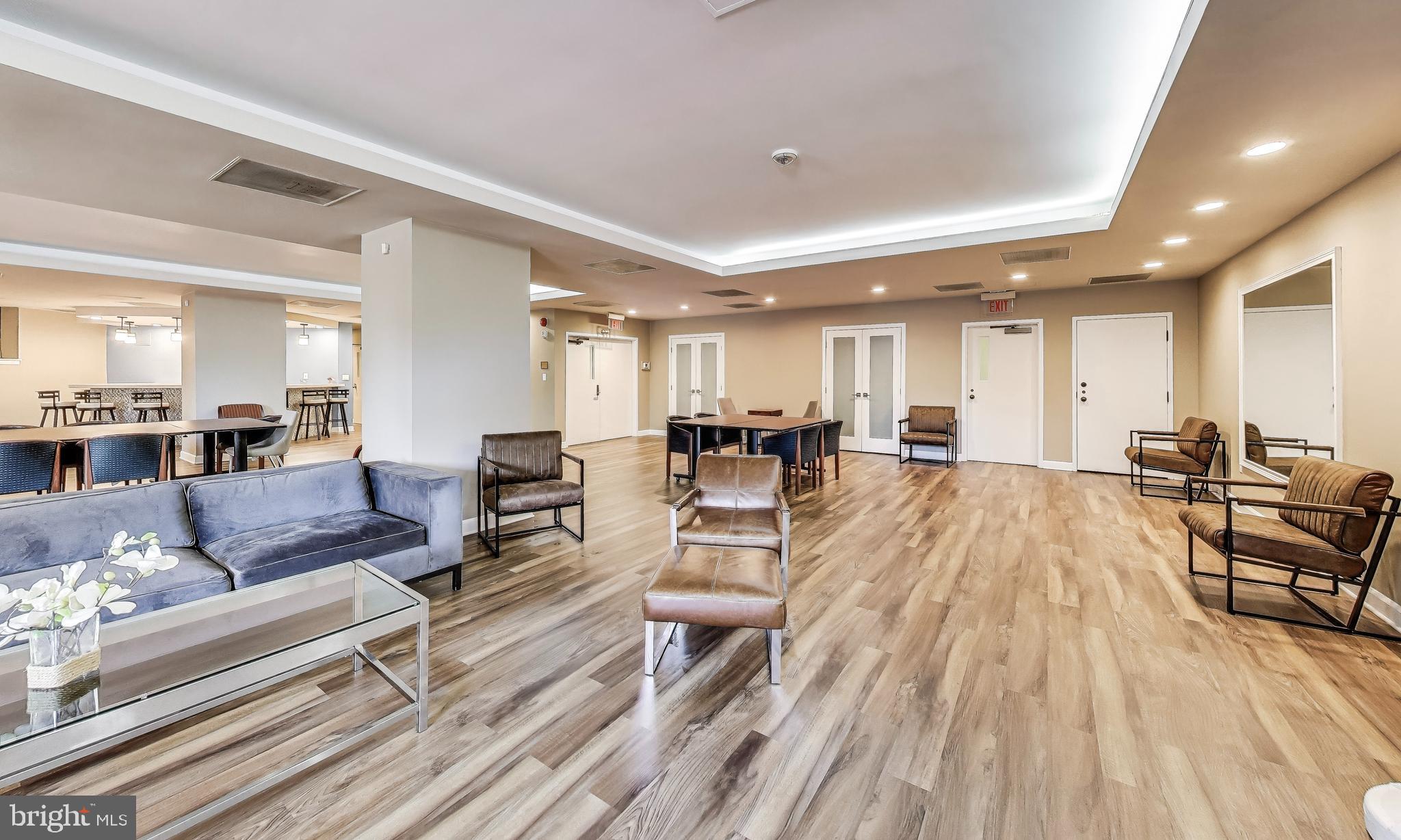 2111 Wisconsin Avenue Northwest, Unit 109 Washington, DC 20007 - Photo 43 of 50 a living room with furniture and a wooden floor