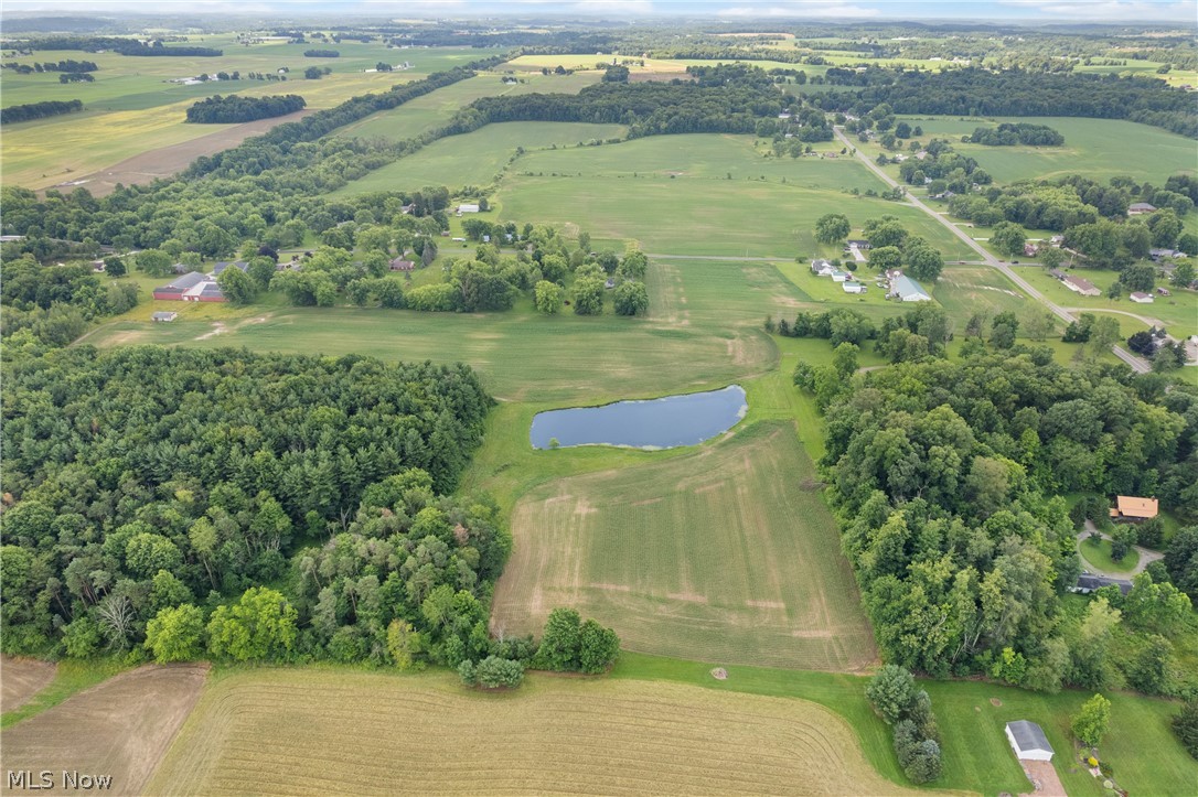 22840 Buck Road Alliance, OH 44601 - Photo 29 of 36 Aerial view of sparsely populated area featuring a large body of water and a tree filled landscape