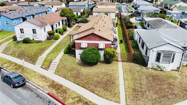 an aerial view of residential houses with yard