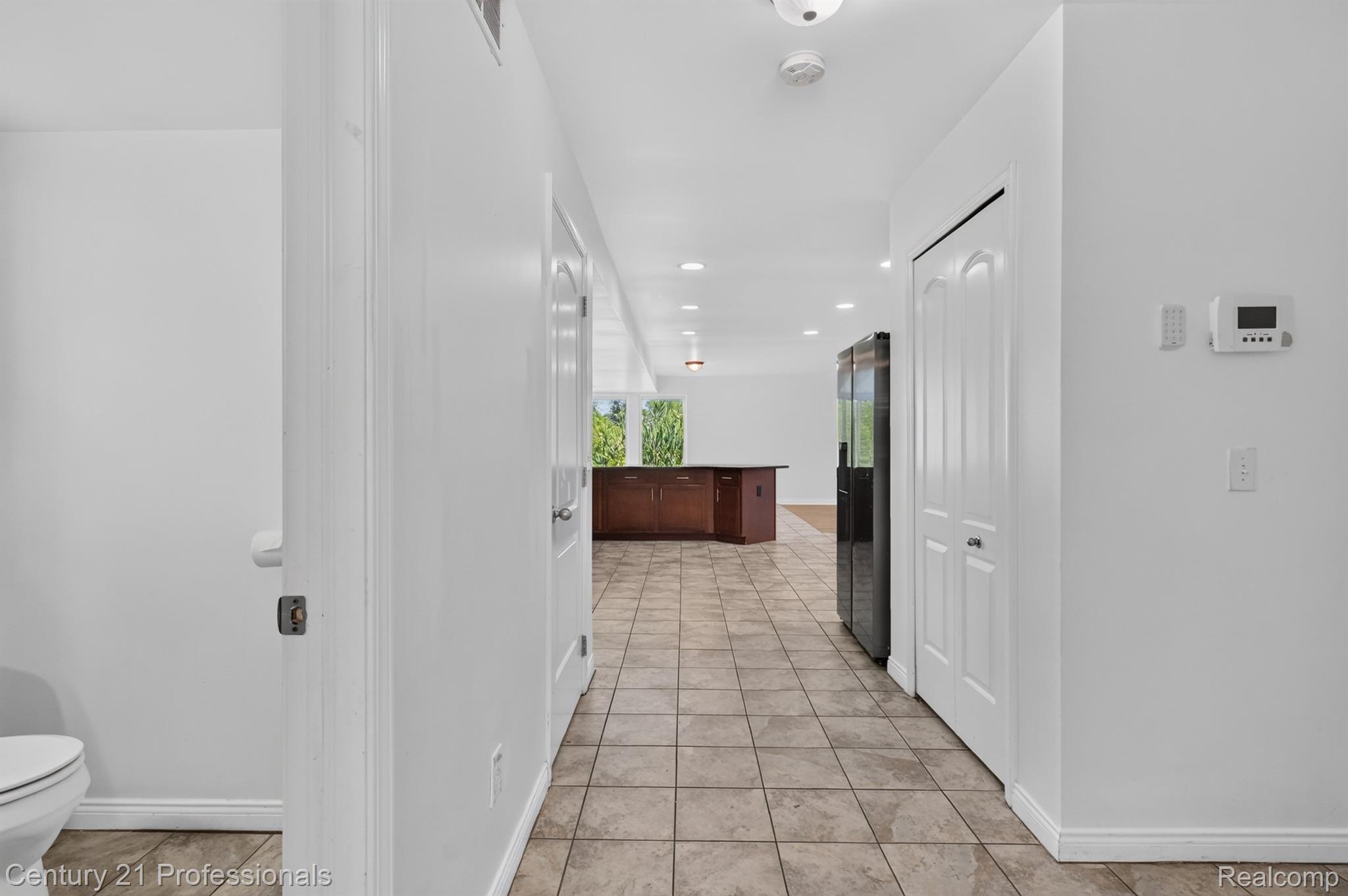 2042 Decker Road Walled Lake, MI 48390 - Photo 17 of 48 Hallway with tile flooring, recessed lighting, and white walls