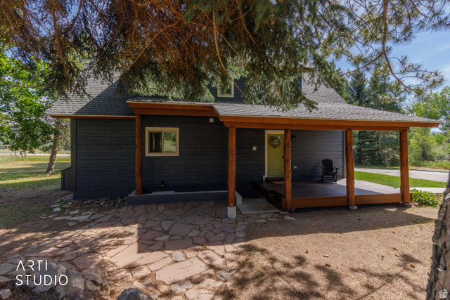 2807 North Ogden Canyon Road Eden, UT 84310 - Photo 51 of 72 Charcoal siding exterior featuring a grey shingle roof and a spacious covered porch with natural wood posts and exposed beams