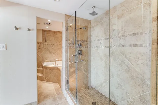 a bathroom with a shower and a sink