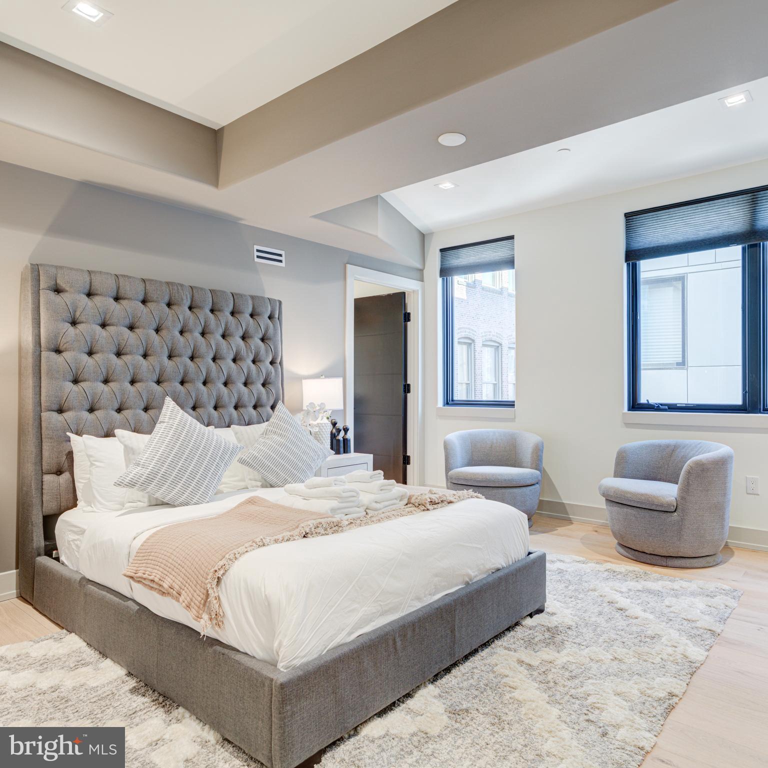 109 South 24th Street Philadelphia, PA 19103 - Photo 36 of 55 a bedroom with a large bed and a couch