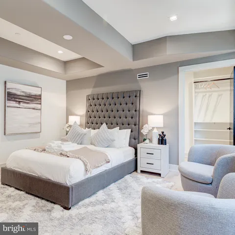 a bathroom with a granite countertop sink mirror and toilet