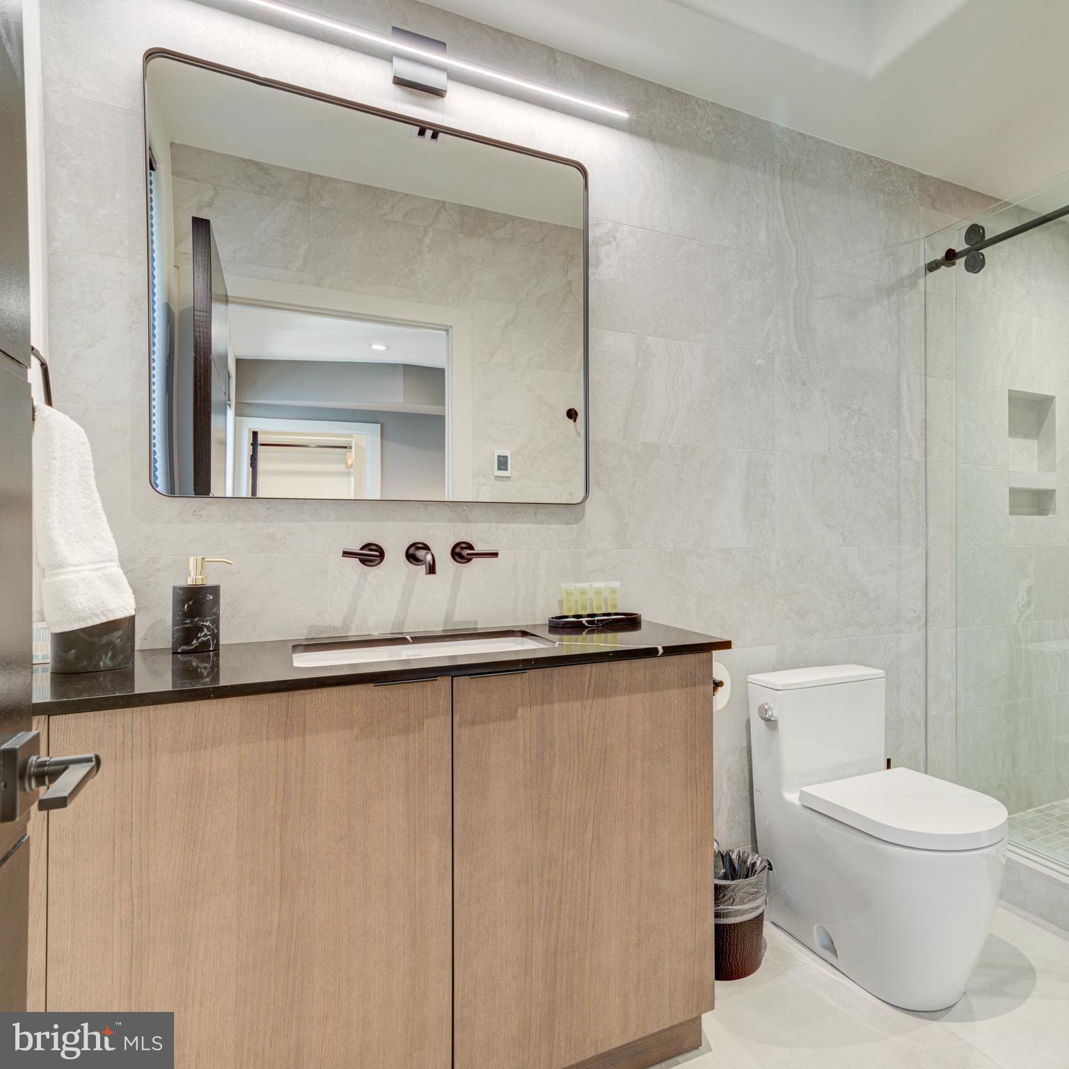 109 South 24th Street Philadelphia, PA 19103 - Photo 40 of 55 a bathroom with a granite countertop sink mirror and toilet