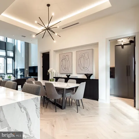 a view of a a dining room with furniture window and wooden floor