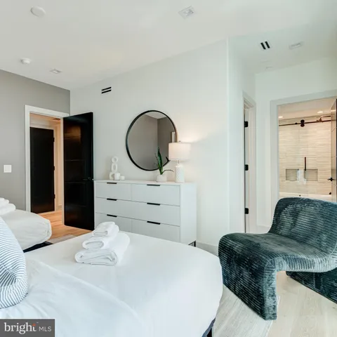 a spacious bedroom with a bed and a window