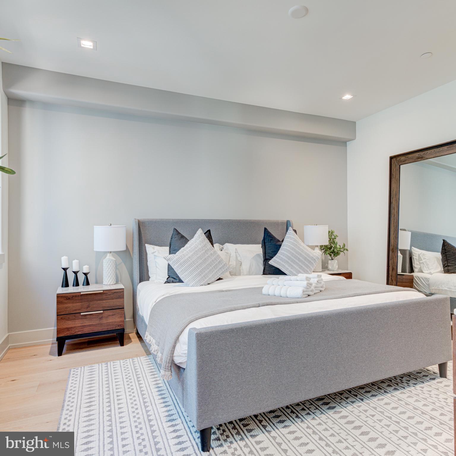 109 South 24th Street Philadelphia, PA 19103 - Photo 48 of 55 a bedroom with a bed and a lamp