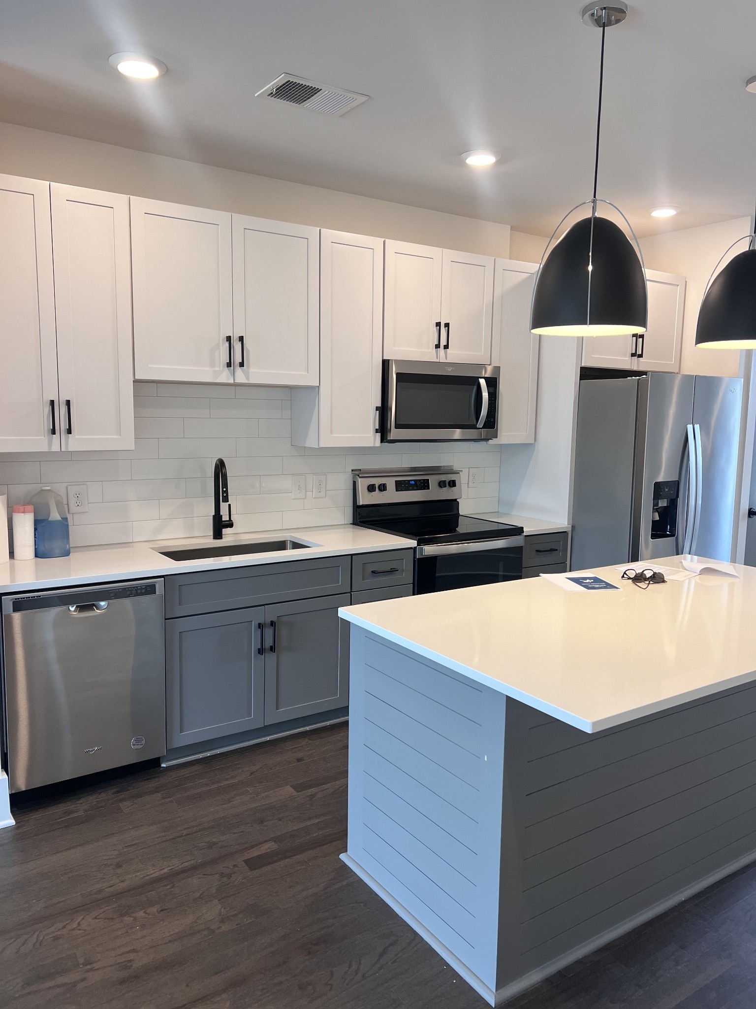 a kitchen with stainless steel appliances granite countertop a sink a stove and a refrigerator