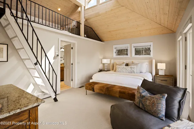 a spacious bedroom with a bed and a couch