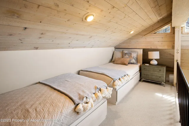 a bedroom with a bed and a night stand