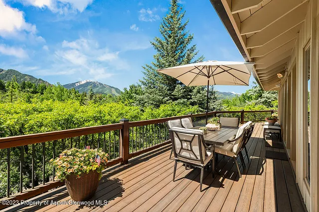 a view of a balcony with furniture and wooden floor