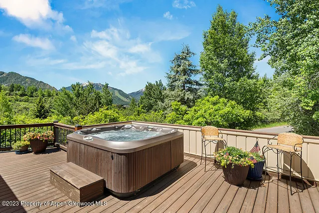 a terrace with outdoor seating and trees