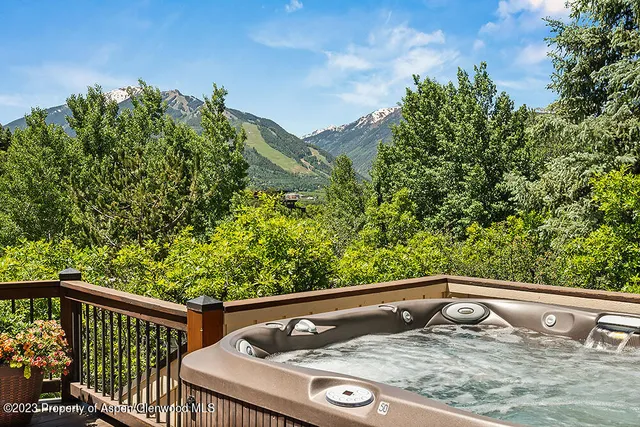 a view of a balcony with wooden floor and fence
