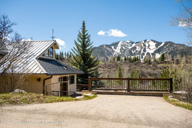 a view of a house with a yard next to a road