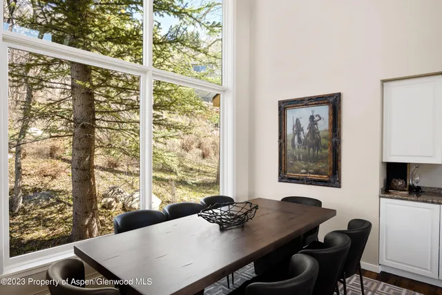 a dining room with furniture and window