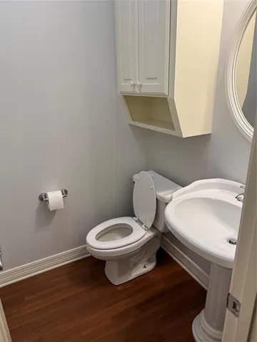 a white toilet sitting next to a bathroom sink