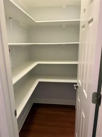 a view of walk in closet with empty racks