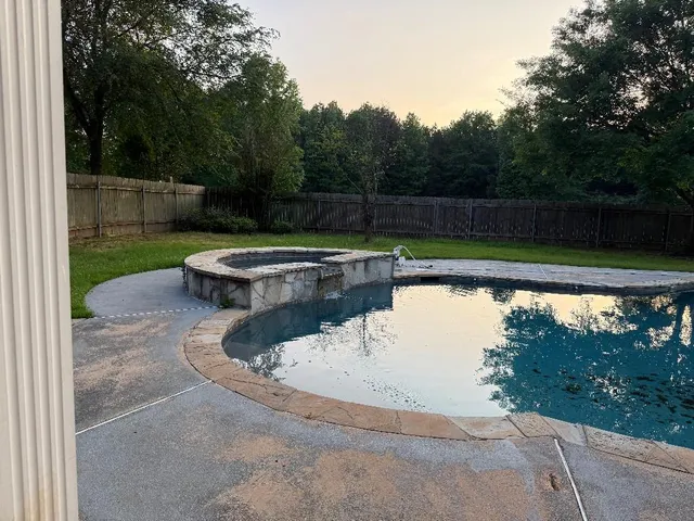 a view of a swimming pool with a yard