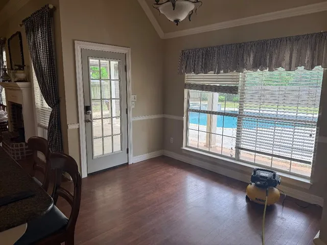 a view of a livingroom with wooden floor and a window
