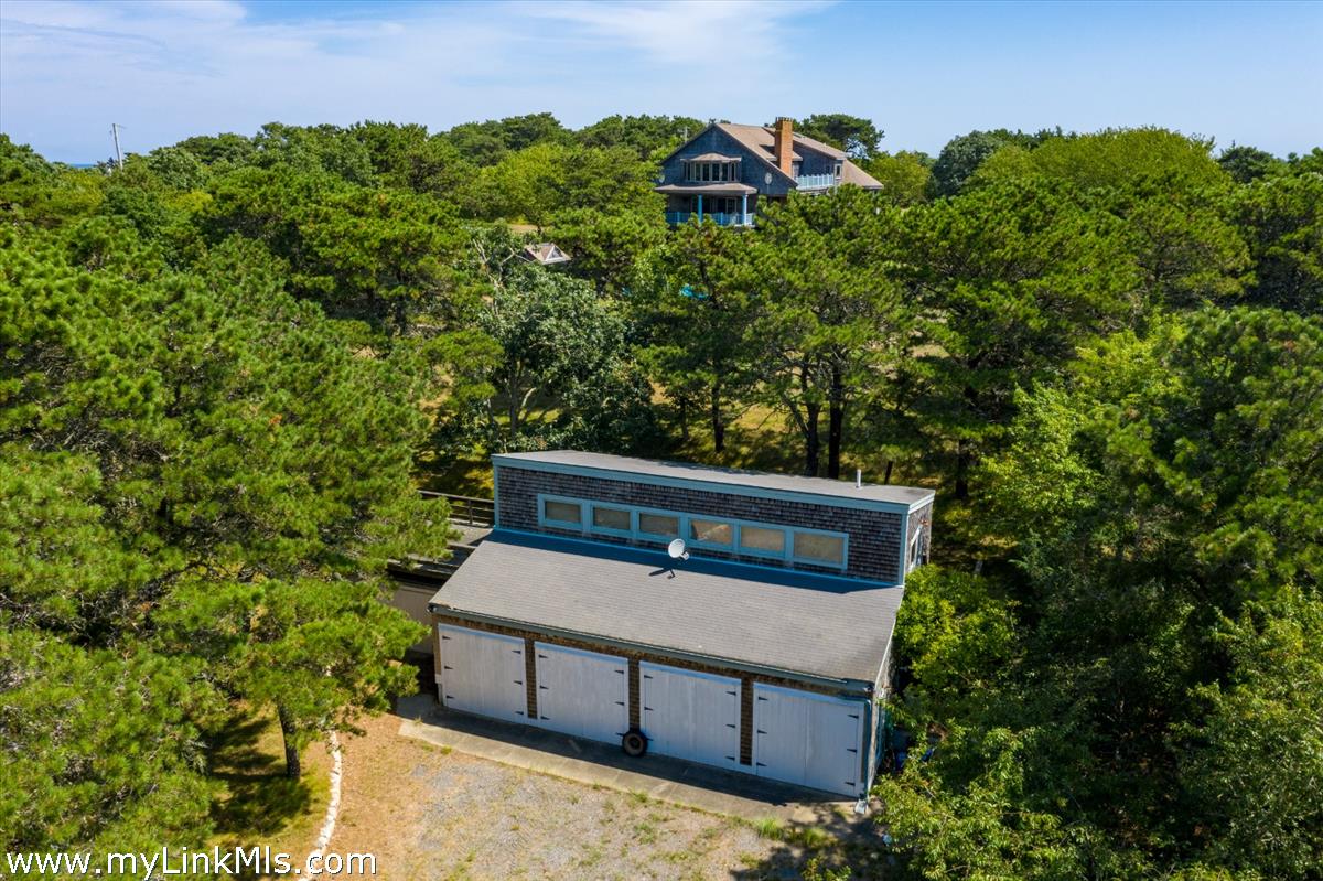 56 North Neck Road Edgartown, MA 02539 - Photo 33 of 63 a view of a wooden bench and a tree in the background