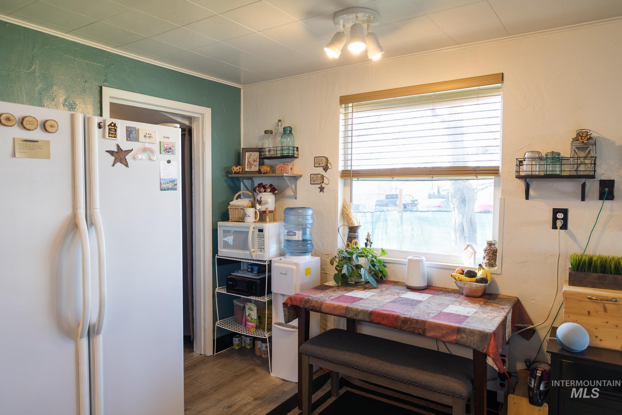 211 Northeast 3rd Avenue Ontario, OR 97914 - Photo 23 of 40 Dining space with crown molding and dark wood-style flooring