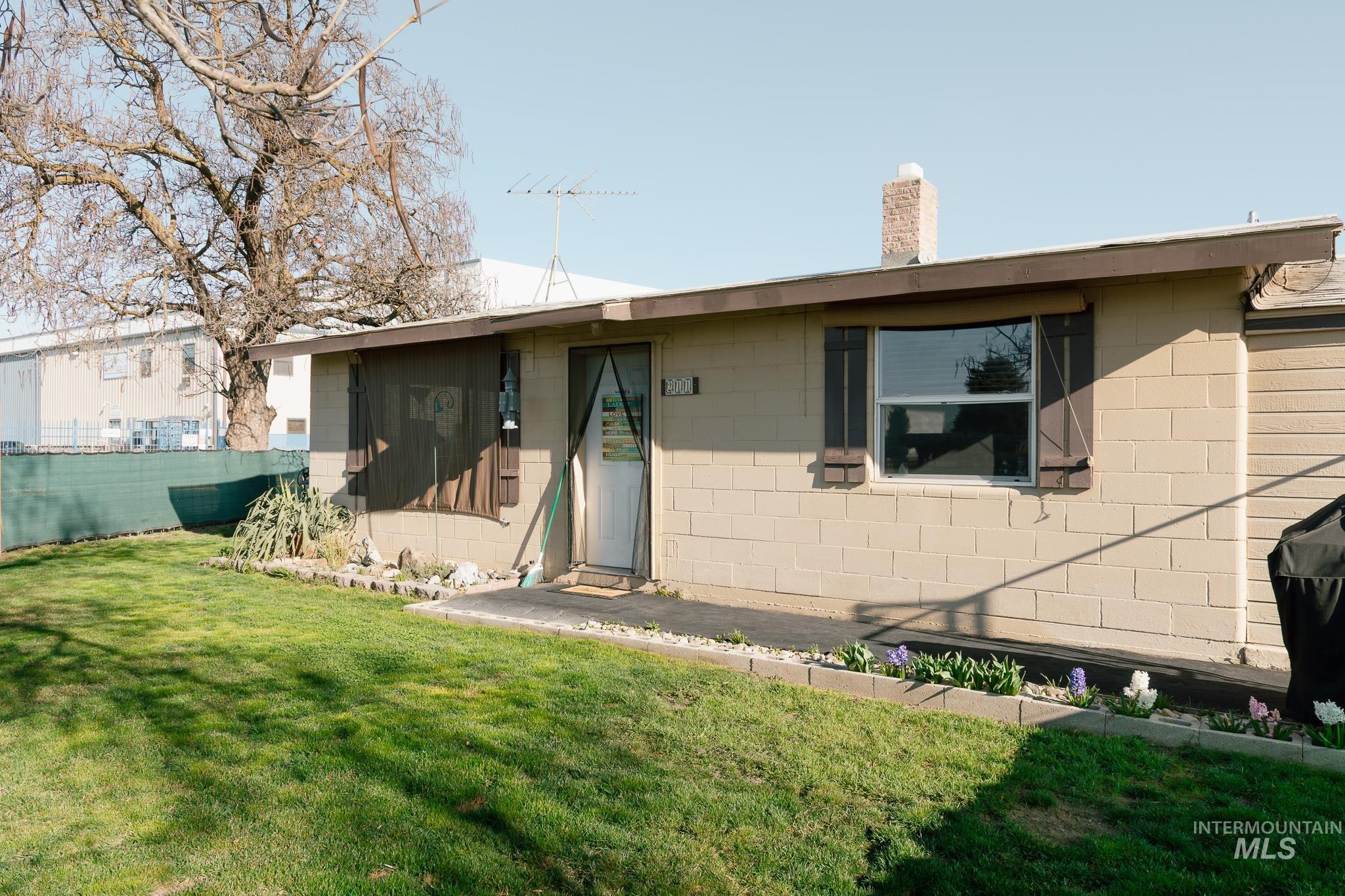 211 Northeast 3rd Avenue Ontario, OR 97914 - Photo 3 of 40 View of front of property with concrete block siding and a chimney