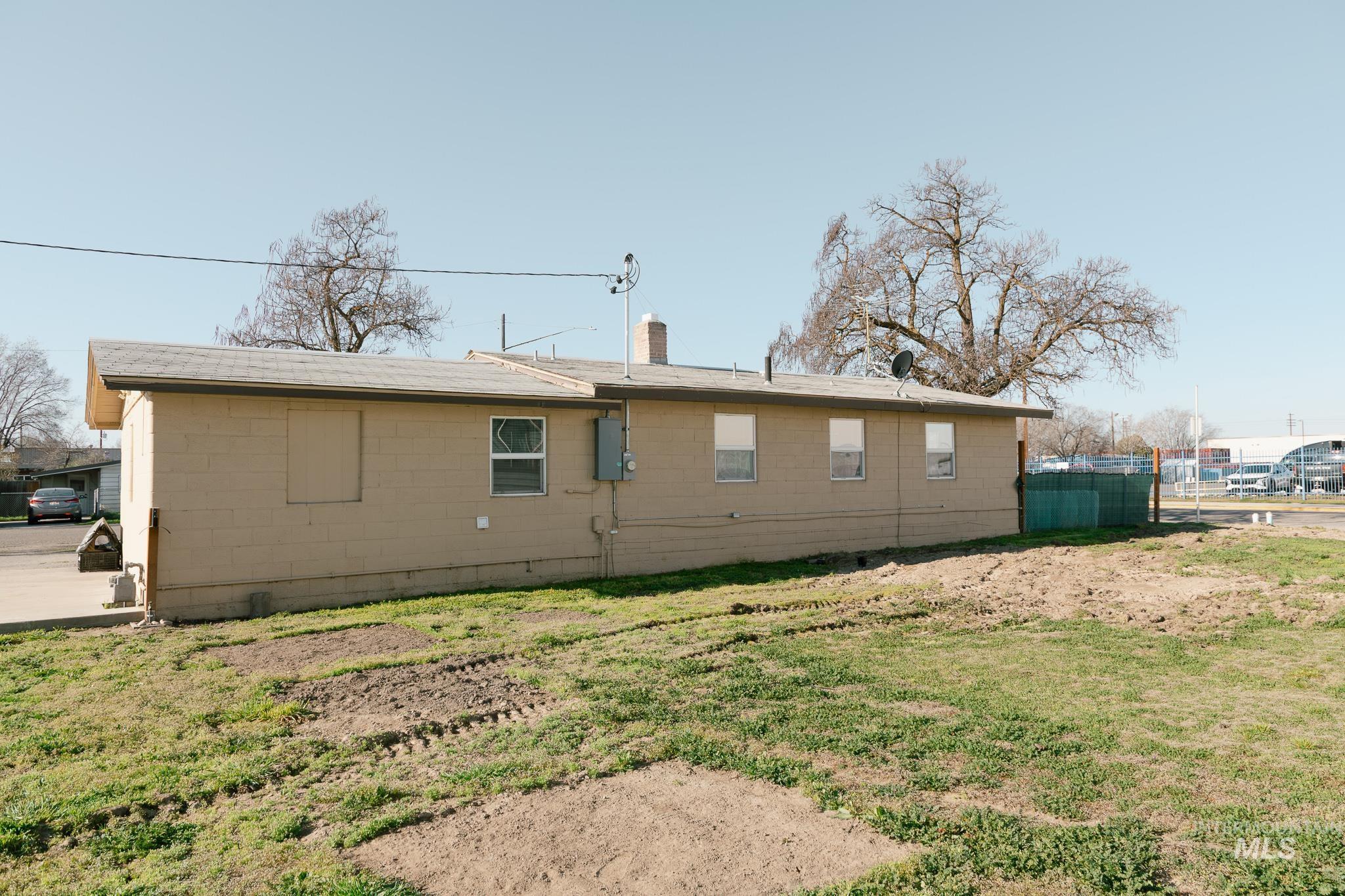 211 Northeast 3rd Avenue Ontario, OR 97914 - Photo 8 of 40 Back of property featuring concrete block siding and a chimney