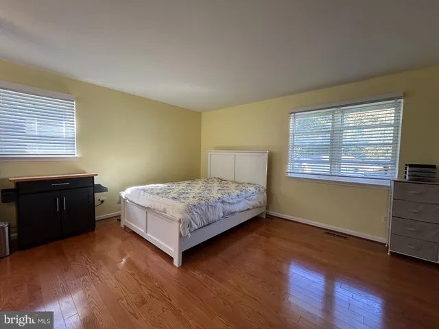 a bathroom with a sink a toilet a mirror and shower curtain