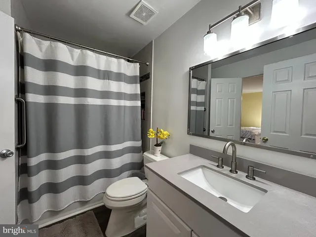 a bedroom with a bed and a desk