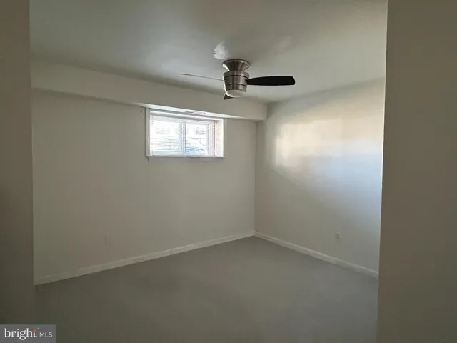a bedroom with a bed and a flat tv screen on the dresser