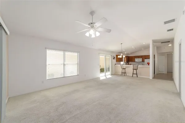 a view of a livingroom with a ceiling fan and window