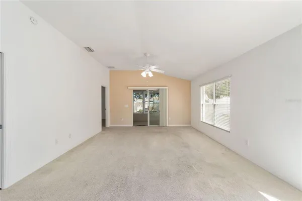 an empty room with windows and closet