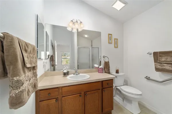 a bathroom with a sink a toilet and mirror
