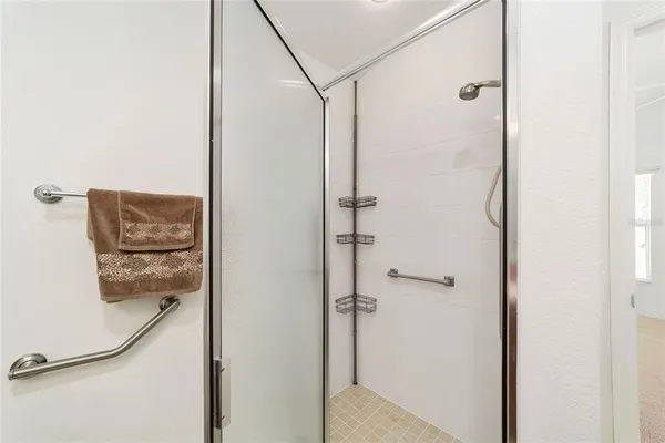 a bathroom with a glass shower door