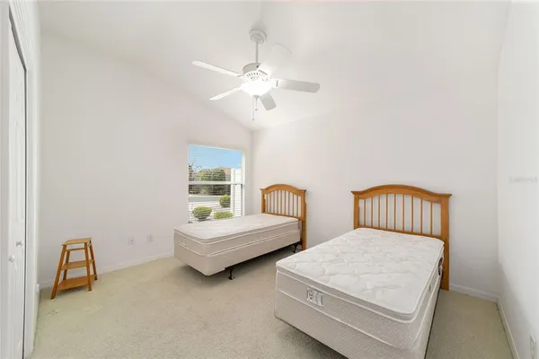 a bedroom with two beds and a chandelier